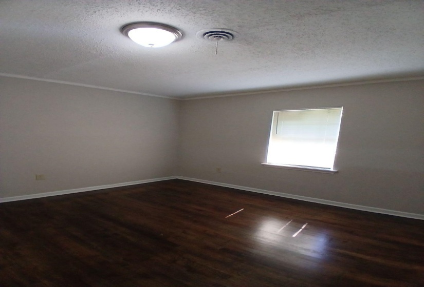 Dark wood-finish flooring complemented by light neutral walls