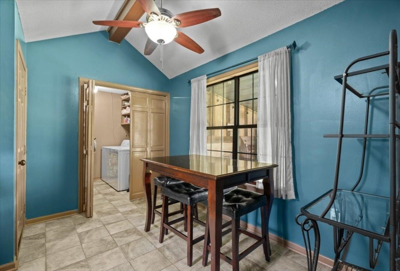 Vaulted ceiling with wood-finish ceiling fan and light fixture