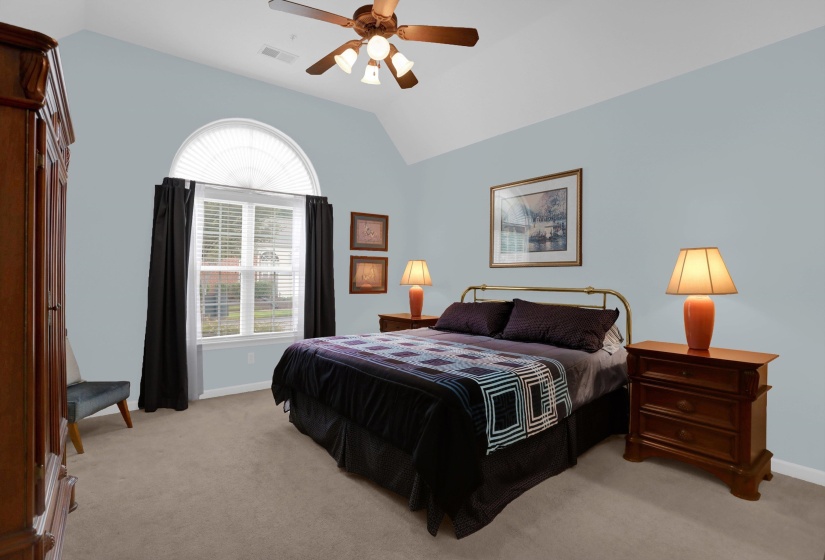 Vaulted ceiling bedroom with arched transom window