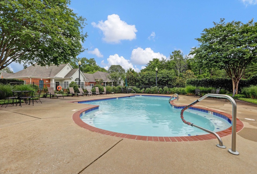 Outdoor swimming pool featuring a brick coping and concrete surround