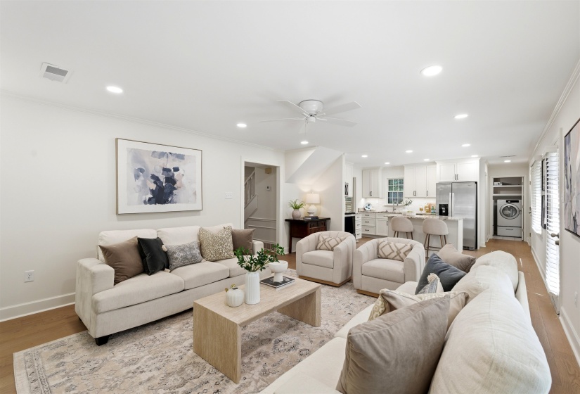 Open-concept living area featuring wood-finish flooring, recessed lighting, and a ceiling fan