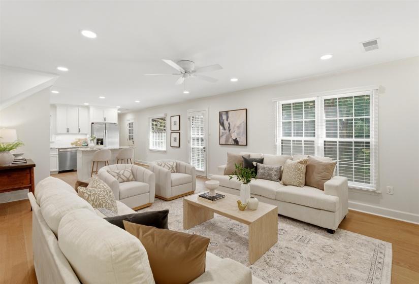 Open-concept living area featuring light wood-finish flooring, recessed lighting, and a ceiling fan