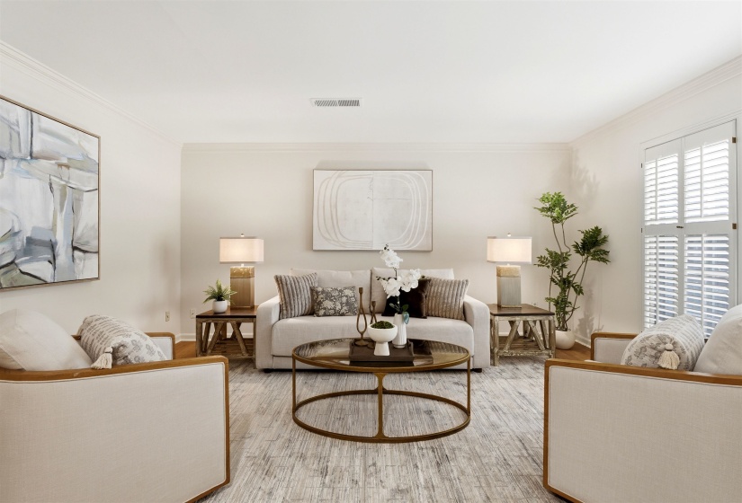 Living area featuring wood-finish flooring, crown molding, and plantation shutters
