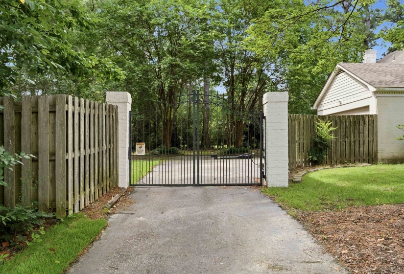 Gated entry with brick columns and wrought iron gates