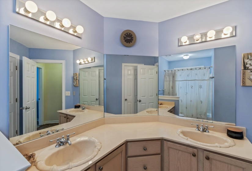 Bathroom featuring double vanity and a shower with shower curtain