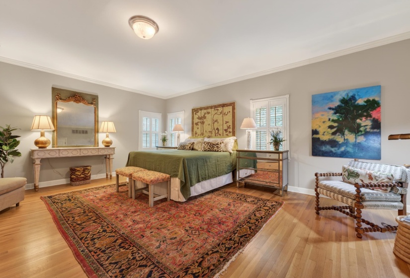 Hardwood flooring complements light gray walls in this spacious room