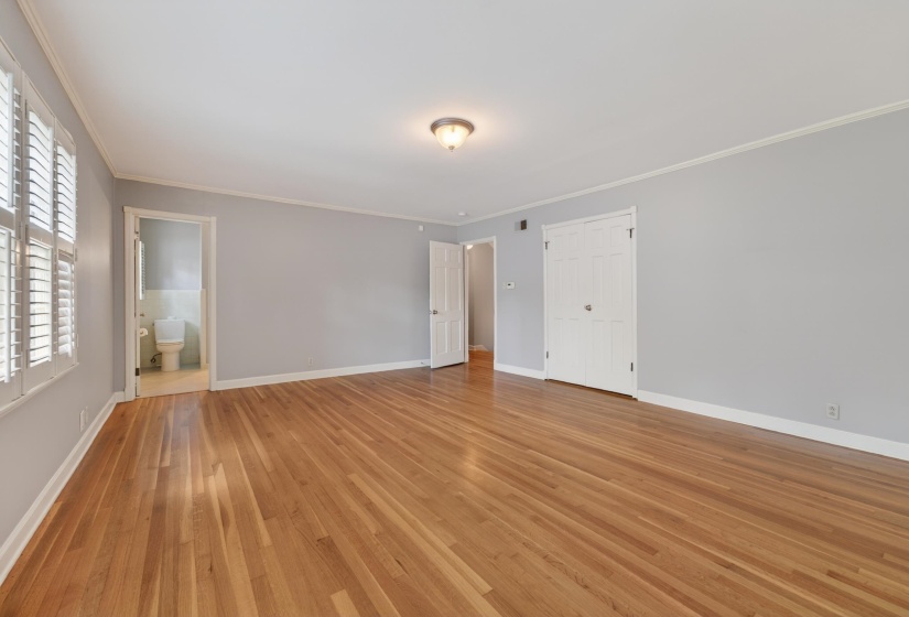 Spacious room featuring wood-finish flooring and light gray painted walls
