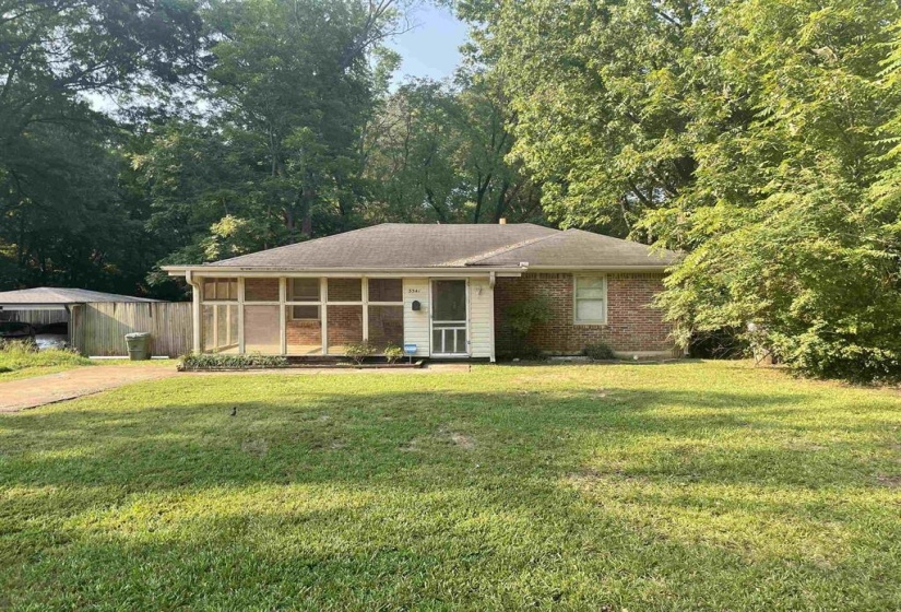 Brick-exterior home with a screened porch entry and a covered carport