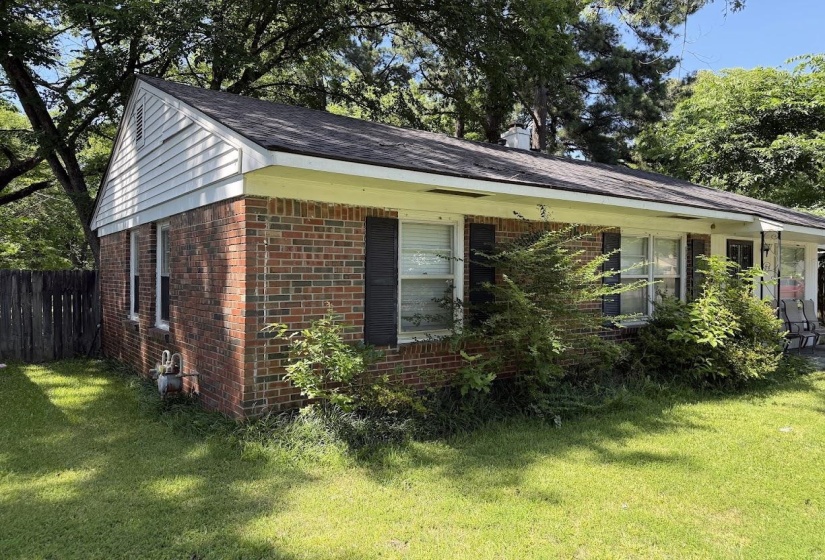 Brick exterior with white siding accents and a dark shingle roof