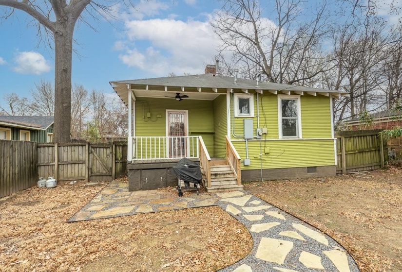 View of front of property with a gate, a fenced backyard, crawl space, a chimney, and ceiling fan