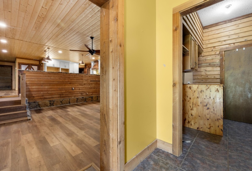 Spacious entertainment area with wood-finish flooring and a wood plank ceiling