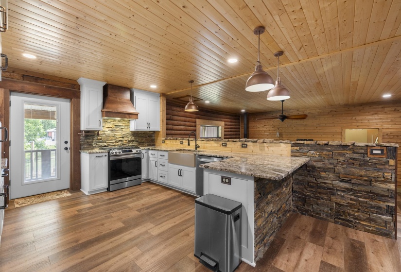 Kitchen featuring wood-finish flooring, white cabinetry, stainless steel appliances, a wood range hood, and stone backsplash