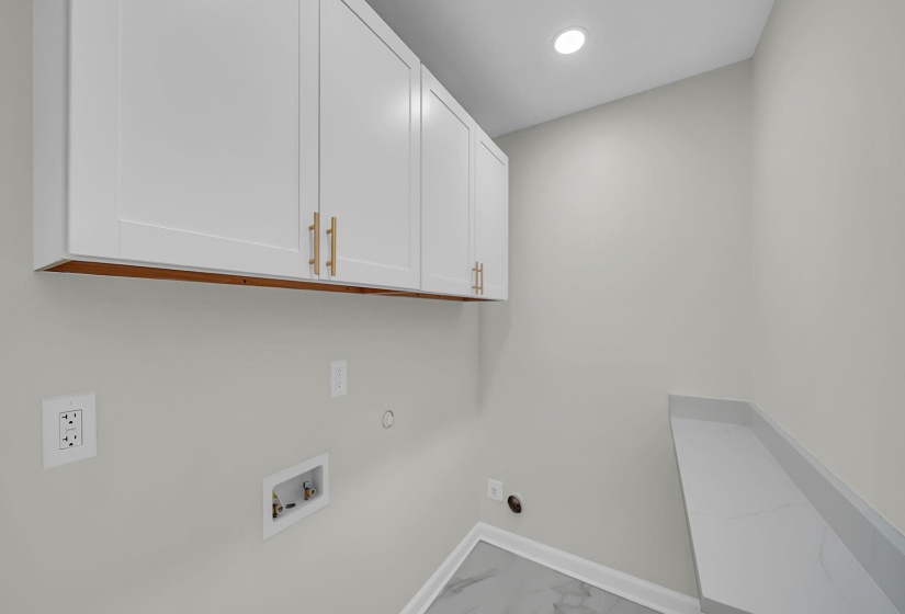 Laundry area featuring hookup for a gas dryer, light marble finish floors, cabinet space, hookup for a washing machine, and recessed lighting