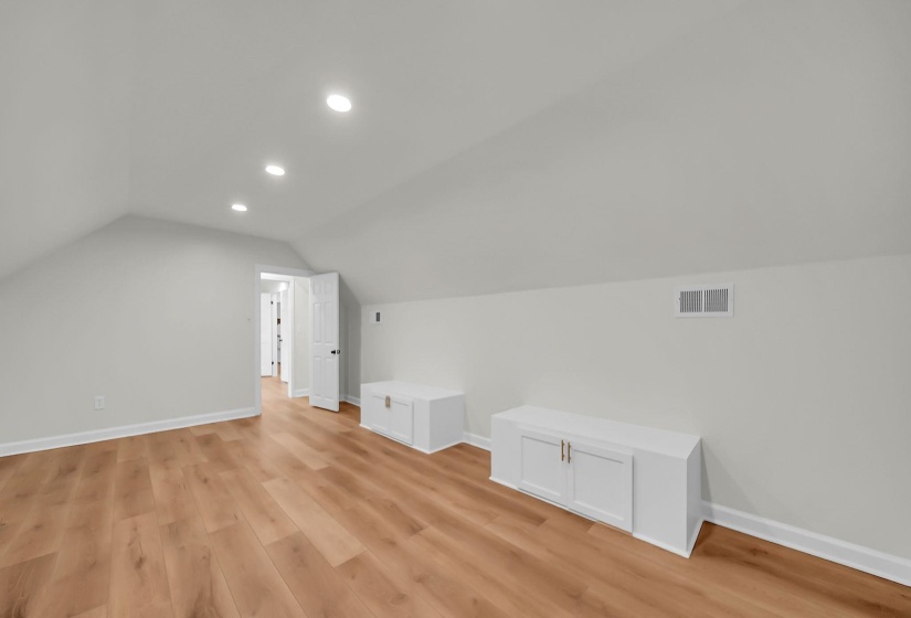 Bonus room featuring recessed lighting, vaulted ceiling, and light wood-style flooring