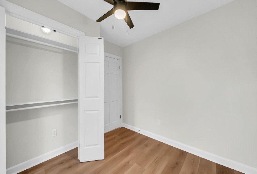 Unfurnished bedroom featuring a closet, light wood finished floors, and a ceiling fan