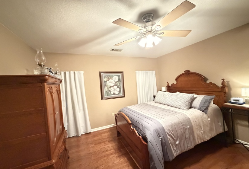Warm wood-finish flooring complements the neutral wall tones