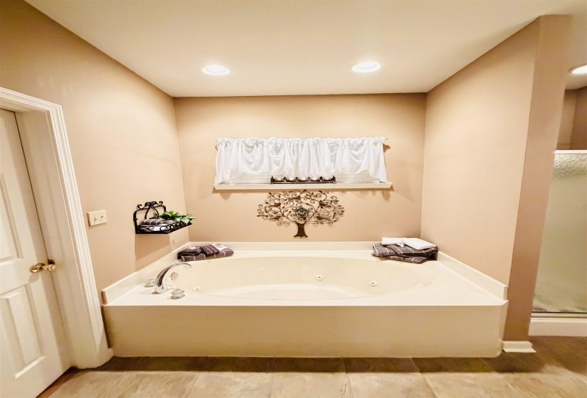 Soaking tub with integrated jets and polished chrome fixtures
