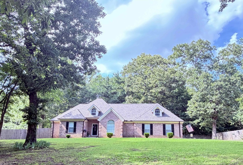 Traditional brick exterior with a gabled roofline and dormer windows