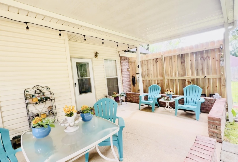Covered patio with string lighting and concrete flooring