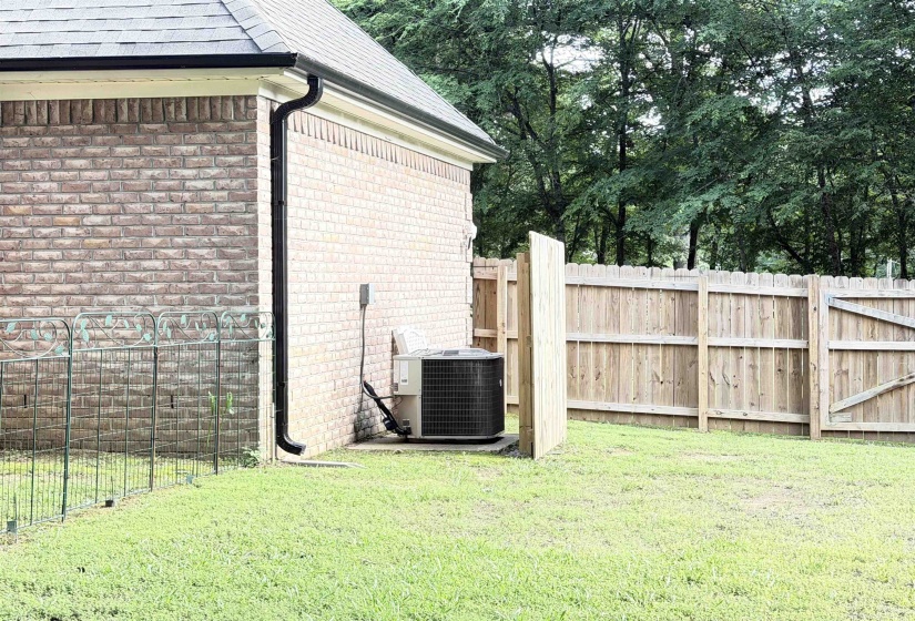 Brick exterior with a dark shingle roof and black gutters