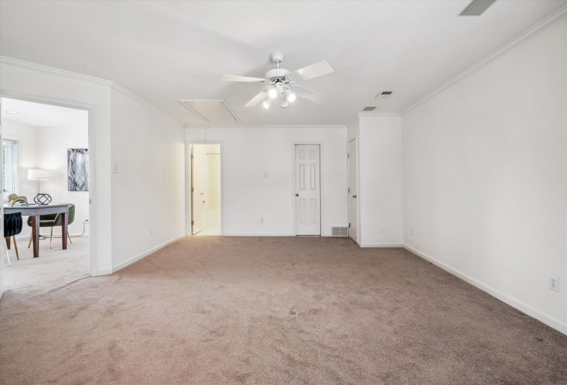 3rd Floor Spacious carpeted room featuring a white ceiling fan with integrated lighting, crown molding, and white trim throughout