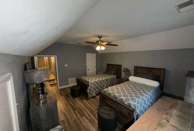 Slanted ceiling space with wood-finish flooring