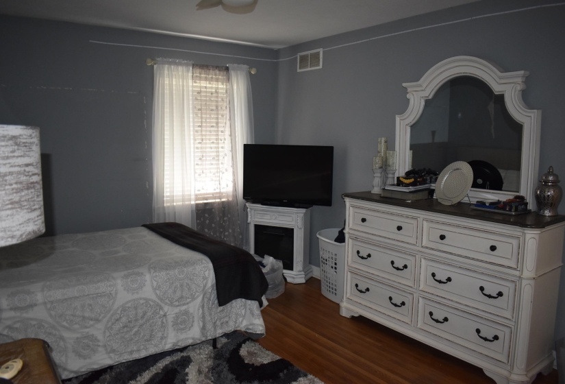 Hardwood flooring complemented by painted walls and a window with blinds