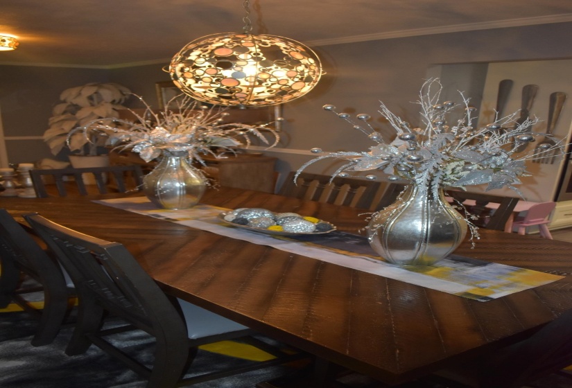 Chevron-patterned wood dining table with dark wood chairs