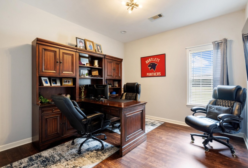 Dedicated office space featuring wood-finish flooring and neutral wall tones