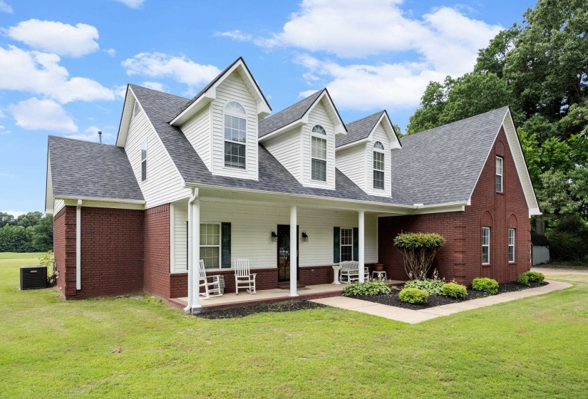 Traditional-style residence featuring a brick and white siding exterior