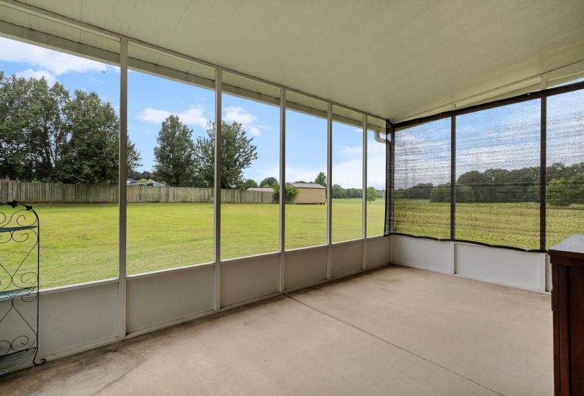 Screened porch with a concrete floor and white framing