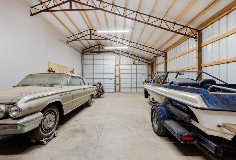 Spacious outbuilding featuring a durable concrete floor, metal siding, and exposed wood framing