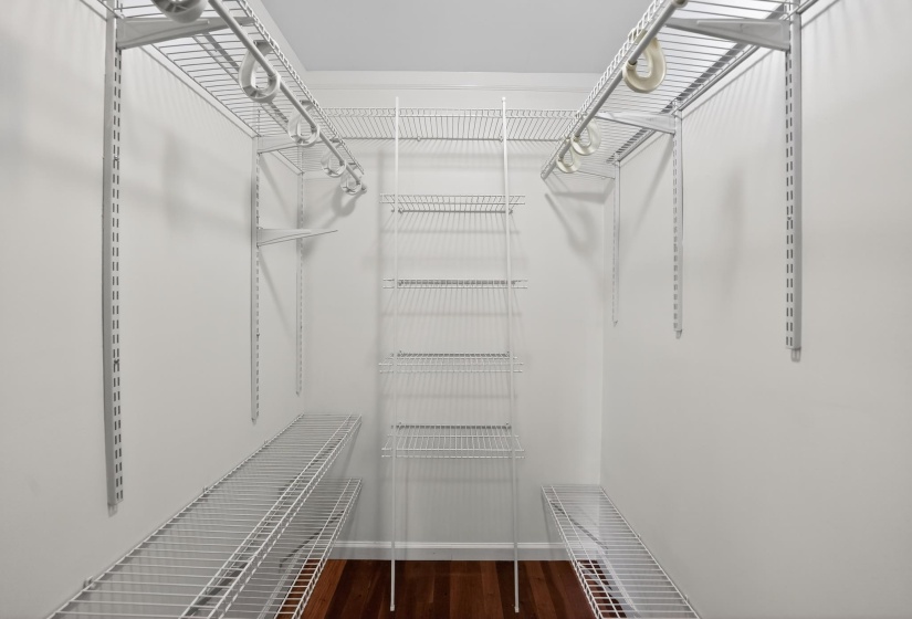Customizable closet system featuring white wire shelving and hanging rods