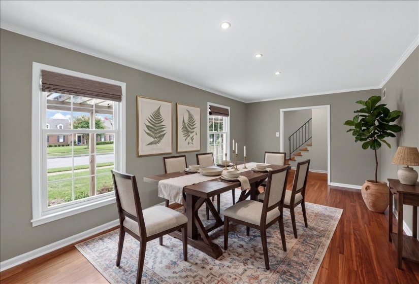 Formal dining space featuring hardwood flooring and crown molding