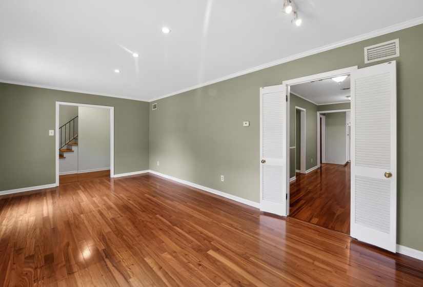 Lustrous wood-finish flooring complements the neutral wall color