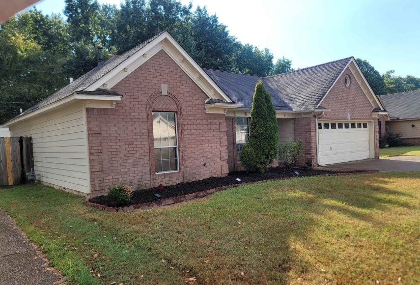 Brick and siding exterior with an attached garage