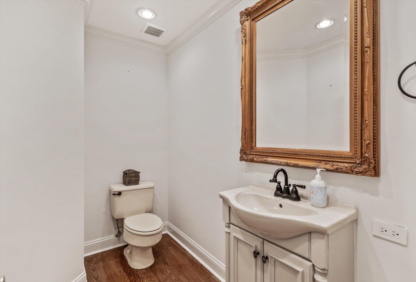 Powder room featuring a white pedestal sink vanity with storage, an ornate gold-framed mirror, and recessed ceiling lighting
