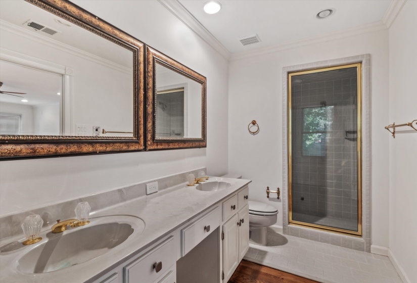 Dual vanity with a white countertop and brass-toned fixtures