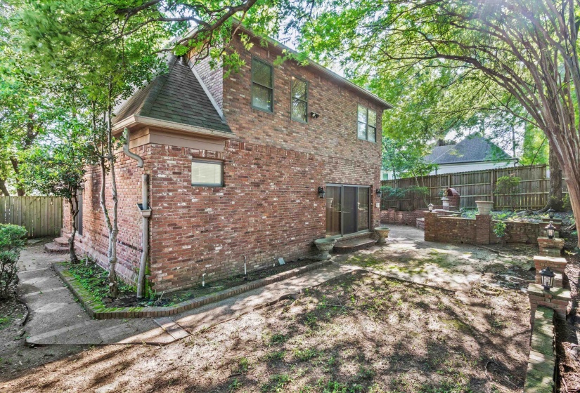 Brick exterior featuring a gabled roofline and multiple windows
