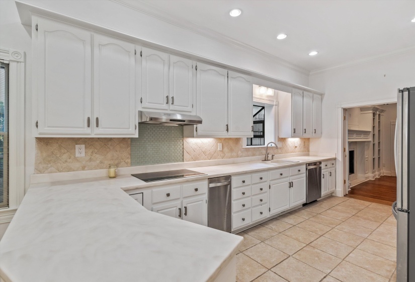 Kitchen featuring white cabinetry with dark hardware, a smooth-surface cooktop, stainless steel appliances, and recessed lighting
