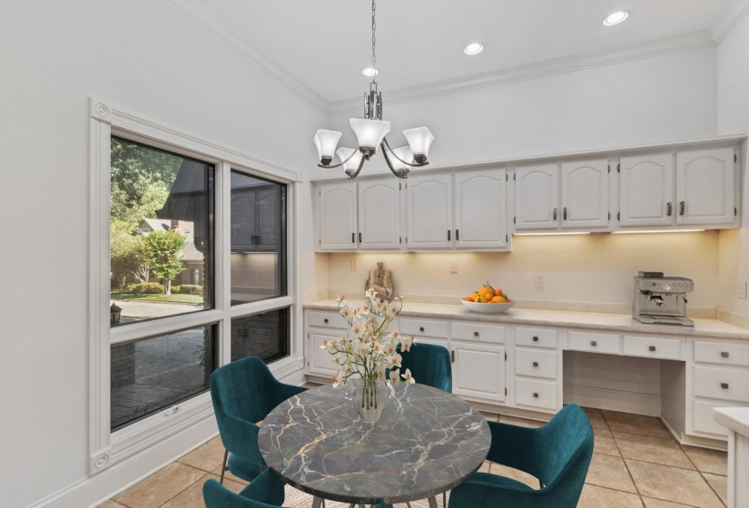 Bright interior space featuring a large picture window, recessed lighting, and a chandelier