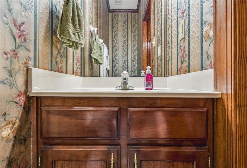 Wood-finish vanity with a white countertop and integrated sink
