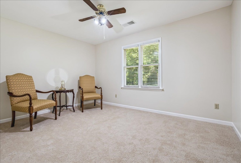 Carpeted room featuring a ceiling fan with integrated lighting, a window with blinds, and light-toned walls with white baseboards