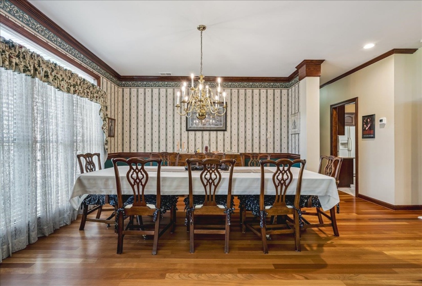 Dining area featuring wood-finish flooring and a brass chandelier