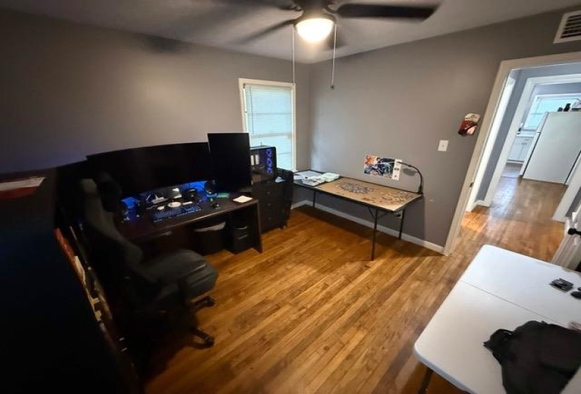 Hardwood flooring and a ceiling fan with integrated lighting
