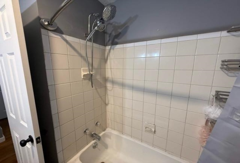 White tile shower surround with a dual-head shower system