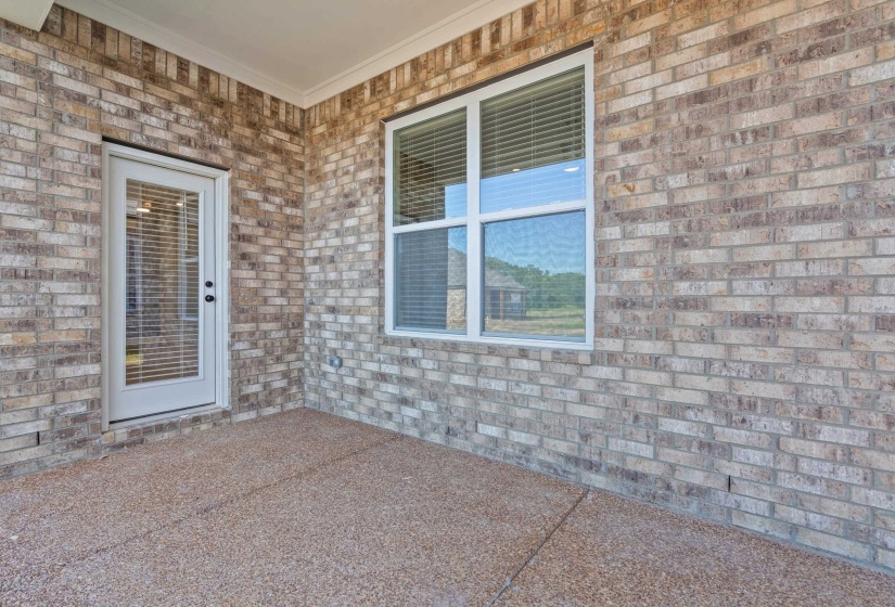 Covered patio area featuring a textured concrete surface