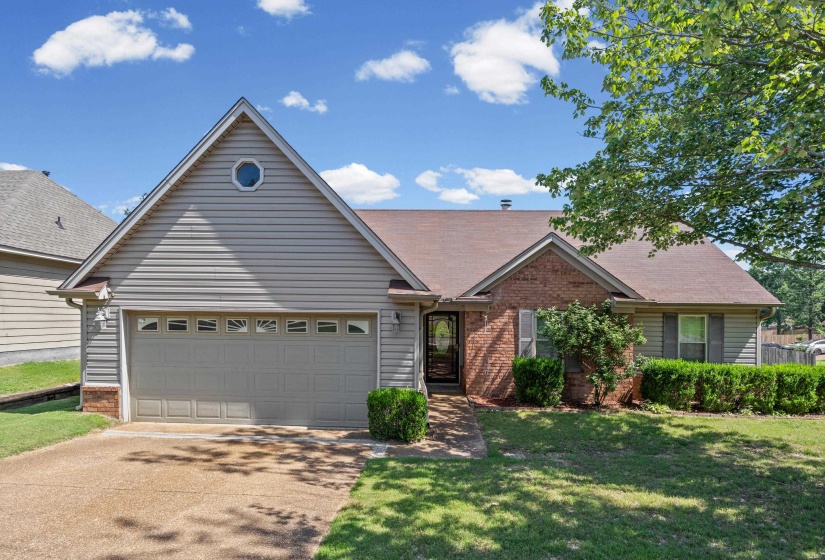 Single-story residence featuring a brick and siding exterior with a gabled roofline