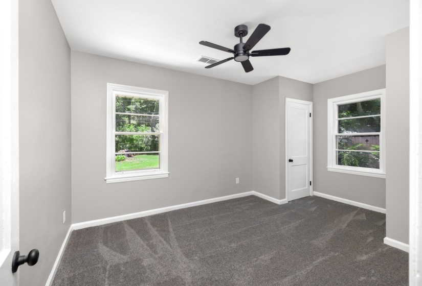 Room featuring neutral gray walls and gray carpeting