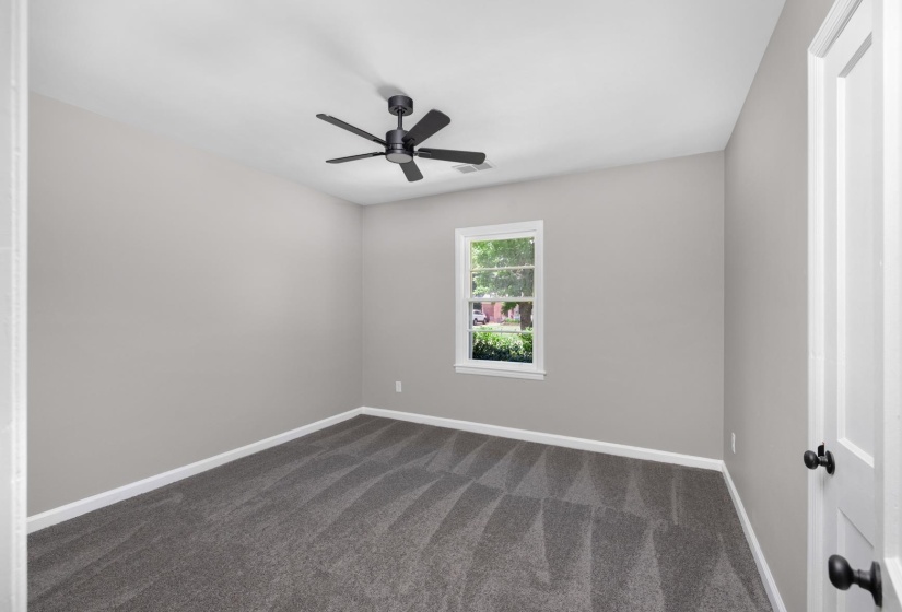 Neutral-toned walls complement the gray carpeting in this room